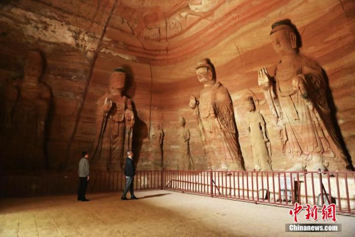 7月15日，游人參觀甘肅省平?jīng)鍪袥艽h百里石窟長廊中的南石窟寺1號窟。百里石窟長廊位于涇川縣境內(nèi)，由512個石窟、5眼窟中石井組成，現(xiàn)存王母宮石窟、鳳凰山石窟、南石窟寺、丈八寺石窟、羅漢洞石窟、太山寺石窟等規(guī)模較大的石窟群，還有數(shù)量眾多的小石窟群。南石窟寺開鑿于北魏永平三年，其中1號窟屬于大型七佛窟，七佛高達(dá)6米。中新社記者 李亞龍 攝